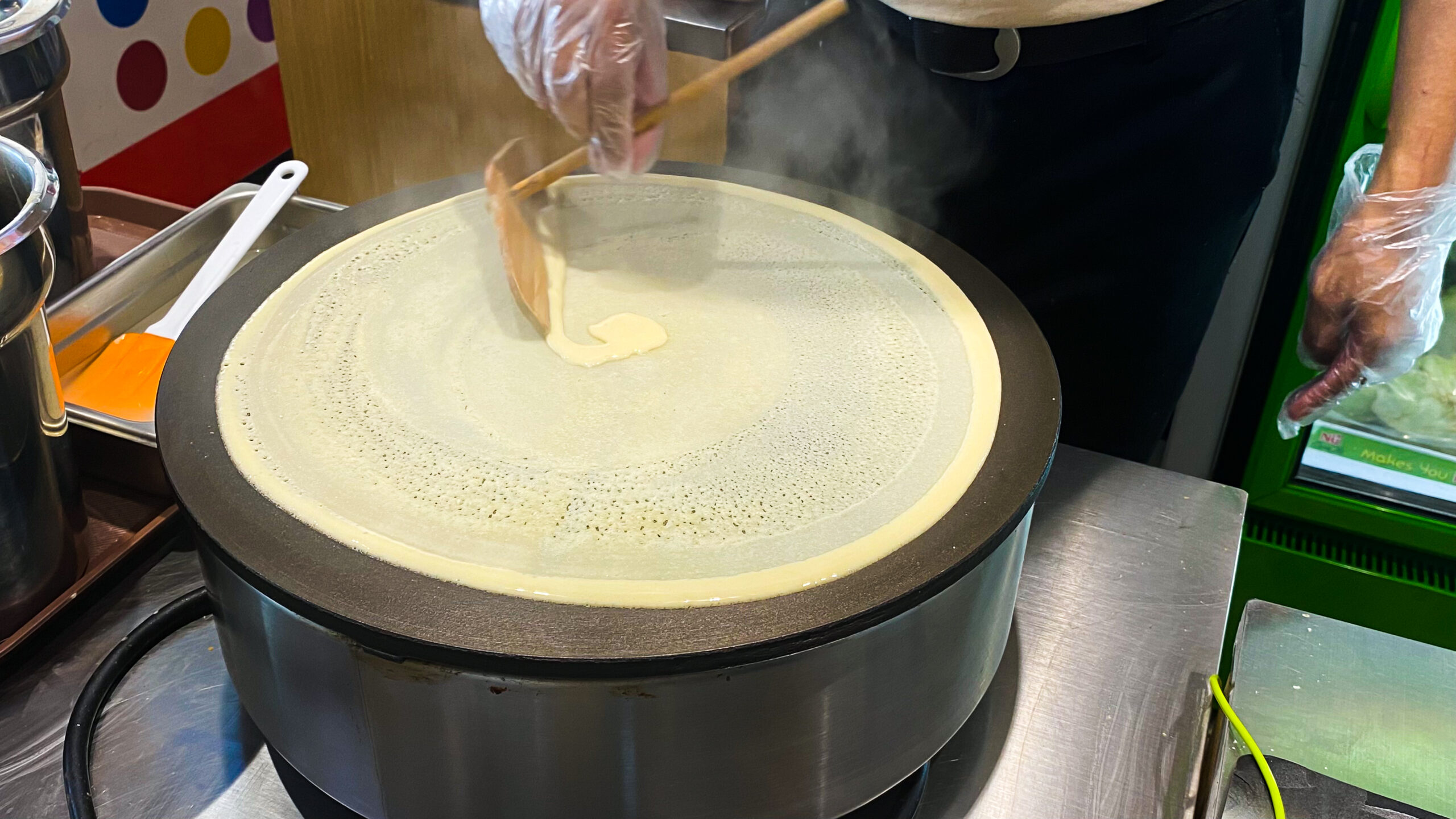 commercial crepe mix batter spreading evenly griddle